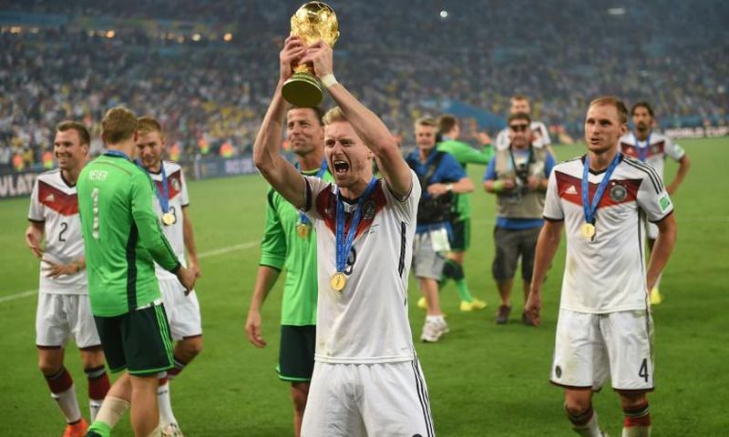 Germany forward Andre Schuerrle holds up the World Cup trophy in Rio de Janeiro after Germany won the final of Brazil 2014.