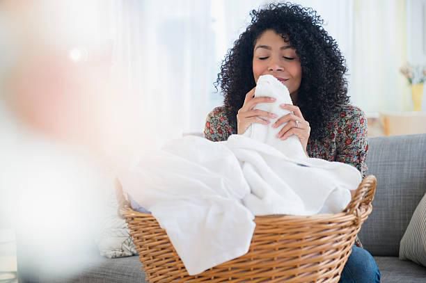 Woman folding white laundry