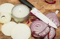 Onions being cut near a candle