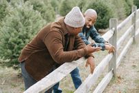 Father having a conversation with his son near a countryside fence [Photo: Any Lane]