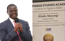 A collage image of Kiraitu Murungi and his certificate in Happiness Studies