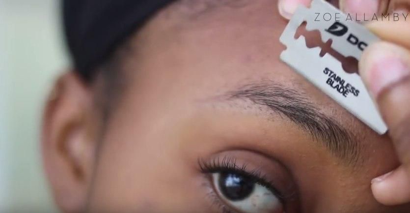 Lady shaving her eyebrows using a Razor blades