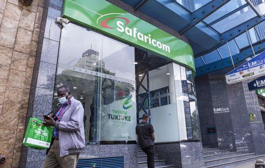 A customer wearing a protective face mask exits a Safaricom Plc store in central Nairobi, Kenya, on Tuesday, May 11, 2021. (Photographer: Patrick Meinhardt/Bloomberg via Getty Images)