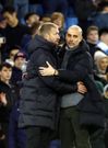 Chelsea head coach Graham Potter (L) congratulates Manchester City manager Pep Guardiola after his side fell to a 0-4 defeat, at the Etihad on January 8, 2023.