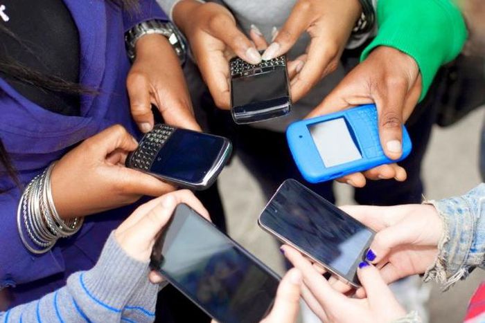 People using their smart phones (Twitter)