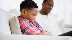 Father and son arguing in a sofa