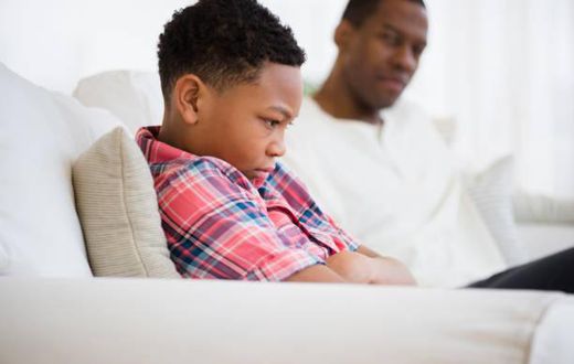 Father and son arguing in a sofa
