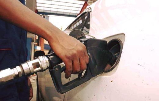An attendant pumps fuel into a car