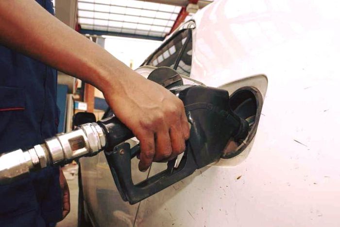 An attendant pumps fuel into a car