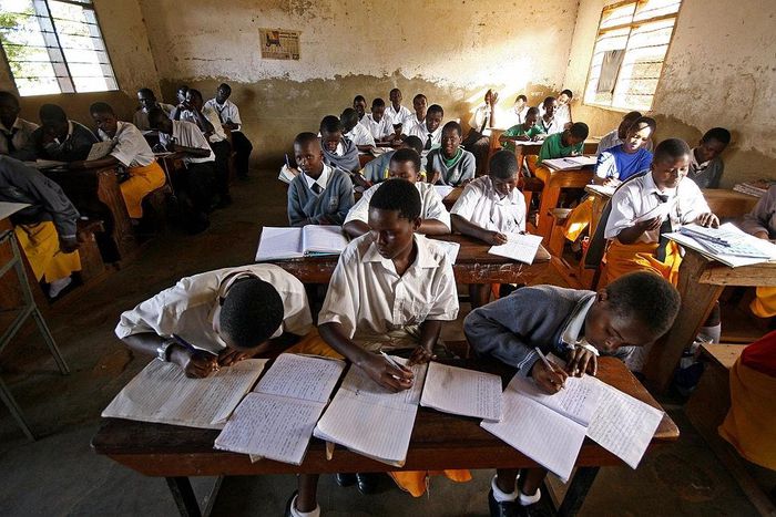 Kampala, UGANDA: Students at St. Denis' Secondary School in Ggaba, a suburb of the capital Kampala, study during the first lesson of the day 23 March 2007. The Ugandan government has recently launched the Universal Secondary Education (USE) programme w...