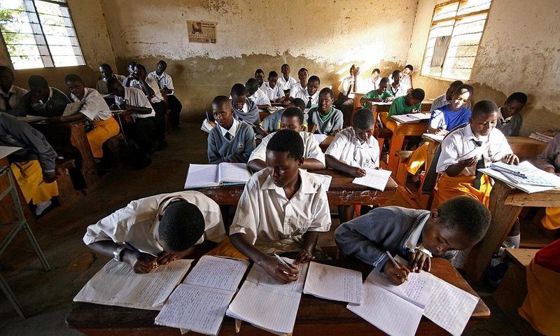 Kampala, UGANDA: Students at St. Denis' Secondary School in Ggaba, a suburb of the capital Kampala, study during the first lesson of the day 23 March 2007. The Ugandan government has recently launched the Universal Secondary Education (USE) programme w...