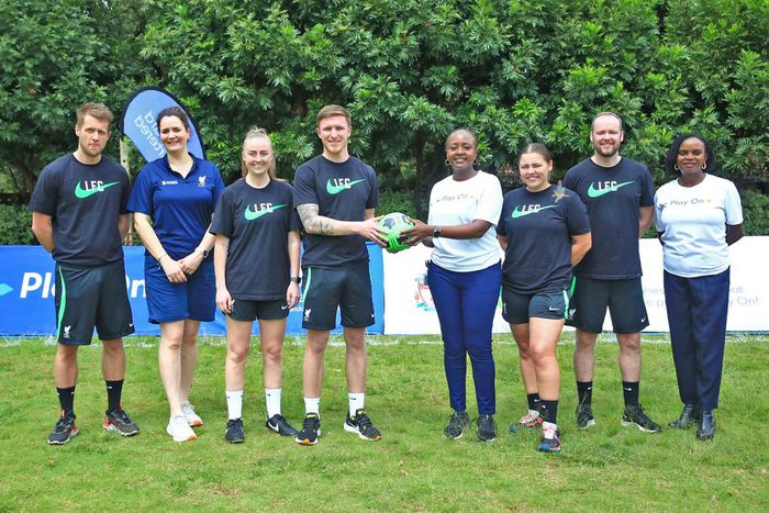 Standard Chartered's Joyce Kibe (centre white shirt) welcomes LFC Coaches to Kenya