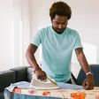 A photo of a man ironing clothes