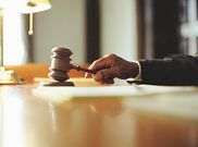 A photo of a judge striking gavel in a courtroom