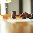A photo of a judge striking gavel in a courtroom