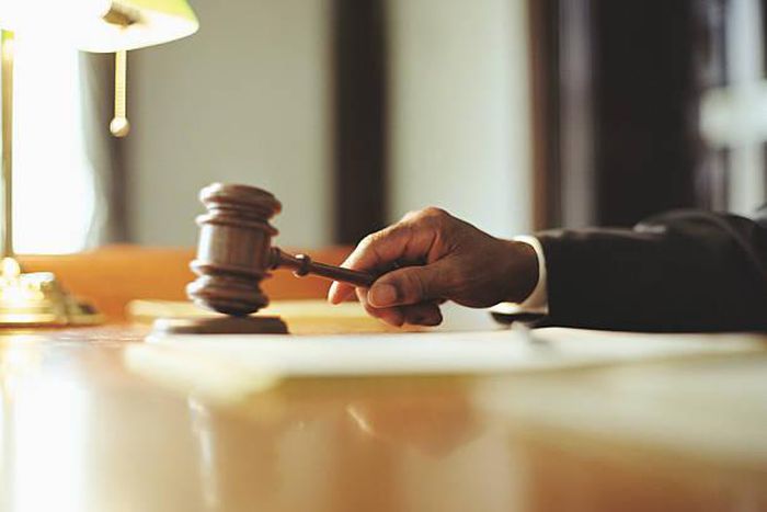 A photo of a judge striking gavel in a courtroom