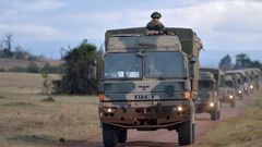 Military vehicles drive during a simulated military excercise of the British Army Training Unit in Kenya (BATUK) together with the Kenya Defence Forces (KDF) at the ol-Daiga ranch, high on Kenyas Laikipia plateau on March 26, 2018.  AFP PHOTO / TONY KA...