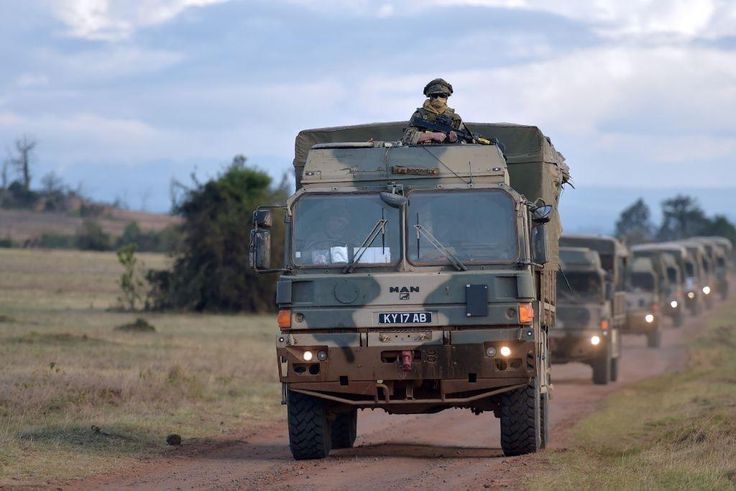 Military vehicles drive during a simulated military excercise of the British Army Training Unit in Kenya (BATUK) together with the Kenya Defence Forces (KDF) at the ol-Daiga ranch, high on Kenyas Laikipia plateau on March 26, 2018.  AFP PHOTO / TONY KA...