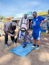 Arap Uria looks on as his bicycle is repaired
