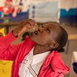 Janet Maloba swallows a dose of the Oral Cholera Vaccine at a vaccination Facility inside Kitengela Sub County Hospital. Credit:  Kelvin Juma