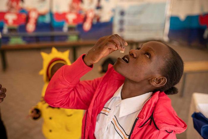 Janet Maloba swallows a dose of the Oral Cholera Vaccine at a vaccination Facility inside Kitengela Sub County Hospital. Credit:  Kelvin Juma