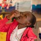 Janet Maloba swallows a dose of the Oral Cholera Vaccine at a vaccination Facility inside Kitengela Sub County Hospital. Credit:  Kelvin Juma