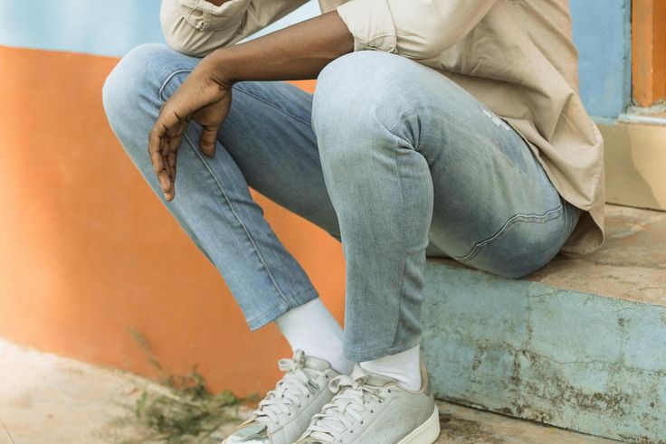 A young man seated in a park thinking