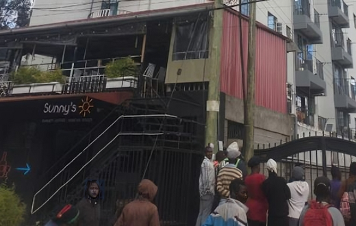 A crowd outside an apartment where a woman was died after reportedly being thrown from one of the houses