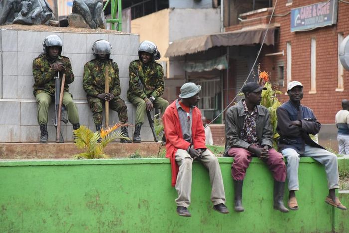 Ant-riot police and members of the public at a street in Kisii town