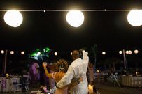 Rear view of couple raising toast at party