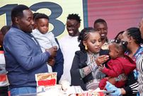 Willis Raburu, Ivy Namu and their children enjoying a cake