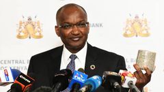 Central Bank of Kenya (CBK) Governor Patrick Njoroge displays a roll of shredded old generation Sh1,000 banknotes at a presss conference in Nairobi on October 2, 2019. (Photo by SIMON MAINA/AFP via Getty Images)
