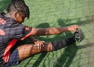 Teen football player warming up [Photo: RF Studio]