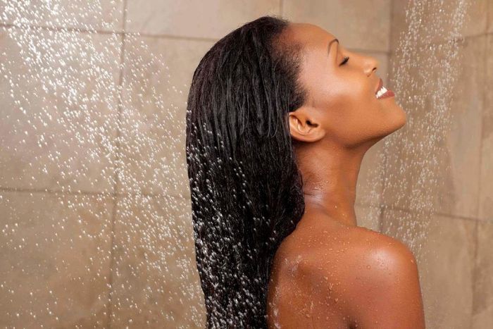 Woman in shower(naturalhairgrowthtips)
