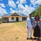 Sammy Kioko and his mother in their newly constructed house