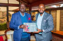 Boniface Mwangi when he met Raila Odinga with his book