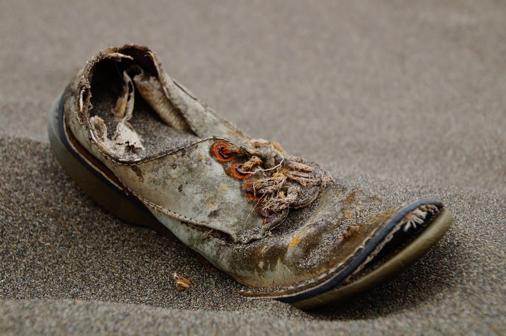 Old brown shoe with bad sole