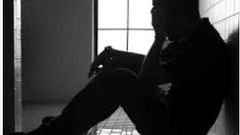 An image depicting a heartbroken man
