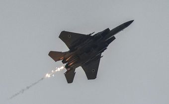 An Israeli air force fighter aircraft releases flares as it flies over along the border with the Gaza Strip near southern Israel on November 12, 2023.Photo by MENAHEM KAHANA/AFP via Getty Images