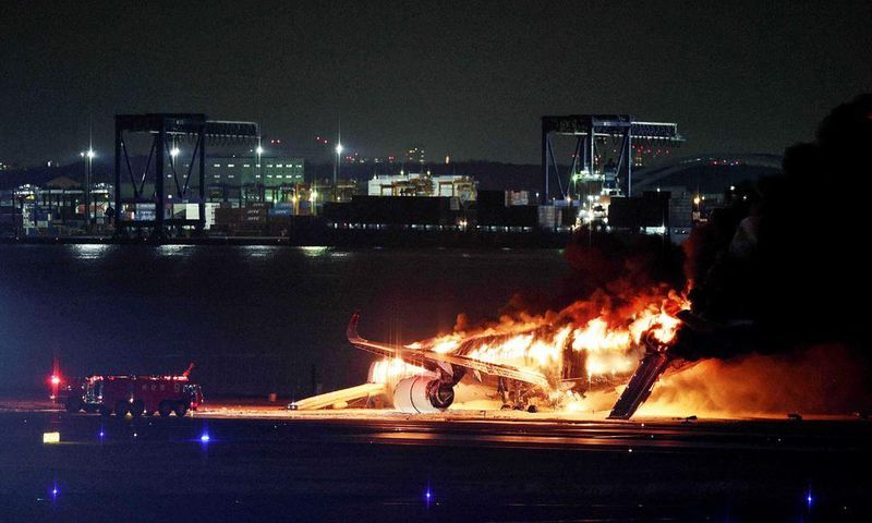 This photo provided by Jiji Press shows a Japan Airlines plane on fire on a runway of Tokyo's Haneda Airport on January 2, 2024.STR/JIJI PRESS/AFP via Getty Images