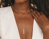 The pendant should reach the lowest point of the V [Etsy]