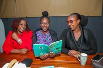 Maria Rehema, Virginia Kamanda and Michelle Chepkwony going through one of the Cadbury storybooks ahead of the official launch held at Bao Box Nairobi.