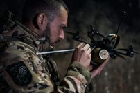 A Ukrainian military pilot of a FPV drone while he attaches an explosive to an FPV drone at the frontline near Bakhmut on October 24, 2023, in Bakhmut, Ukraine.Kostya Liberov / Libkos via Getty Images