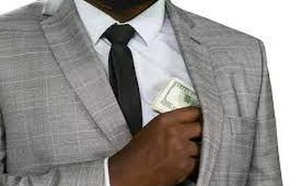 Black man hiding cash [Freepik]