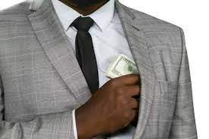 Black man hiding cash [Freepik]