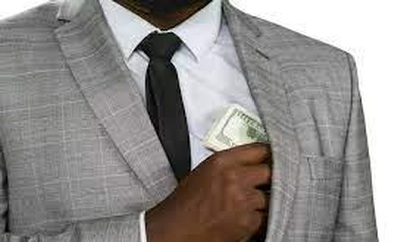 Black man hiding cash [Freepik]