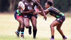 Mwamba's Terry Ayesa (centre) gain grounds from Top Fry Nakuru's Freshia Awino (left) and Yvonne Motari during the Kenya Cup Women's league match played at Impala Club on November 27, 2021. Photo/CHRIS OMOLLO