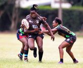 Mwamba's Terry Ayesa (centre) gain grounds from Top Fry Nakuru's Freshia Awino (left) and Yvonne Motari during the Kenya Cup Women's league match played at Impala Club on November 27, 2021. Photo/CHRIS OMOLLO