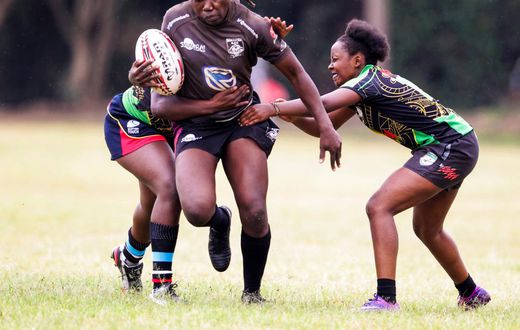 Mwamba's Terry Ayesa (centre) gain grounds from Top Fry Nakuru's Freshia Awino (left) and Yvonne Motari during the Kenya Cup Women's league match played at Impala Club on November 27, 2021. Photo/CHRIS OMOLLO