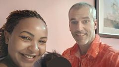 Carolina Carlz and hubby Troy holding their baby